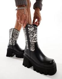 Oferta de Lamoda Viturous chunky heeled western boots with zebra print in black por $90.99 en ASOS