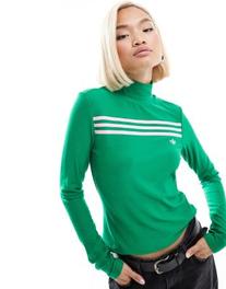 Oferta de Adidas Originals high neck long sleeve jumper in green por $37.5 en ASOS