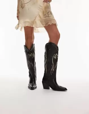Oferta de Bronx Next-low-kole buckle western knee boots in black and snake leather por $240 en ASOS