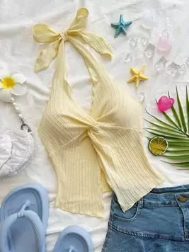 Oferta de Soleia Camiseta sin mangas con escote halter, espalda abierta, dobladillo con abertura y lazo, de estilo sexy y a la moda por $120.6 en SHEIN